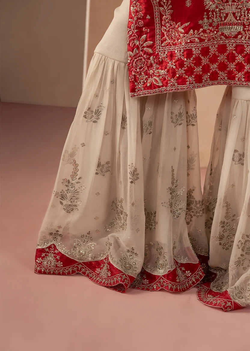 Model wearing red colour dress pakistani as a festive outfit, shop the embroidered silk 3-piece set at Buraqstore