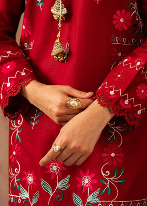 Model wearing red colour dress, side view showing the fit of the embroidered lawn 2PC, Buraqstore