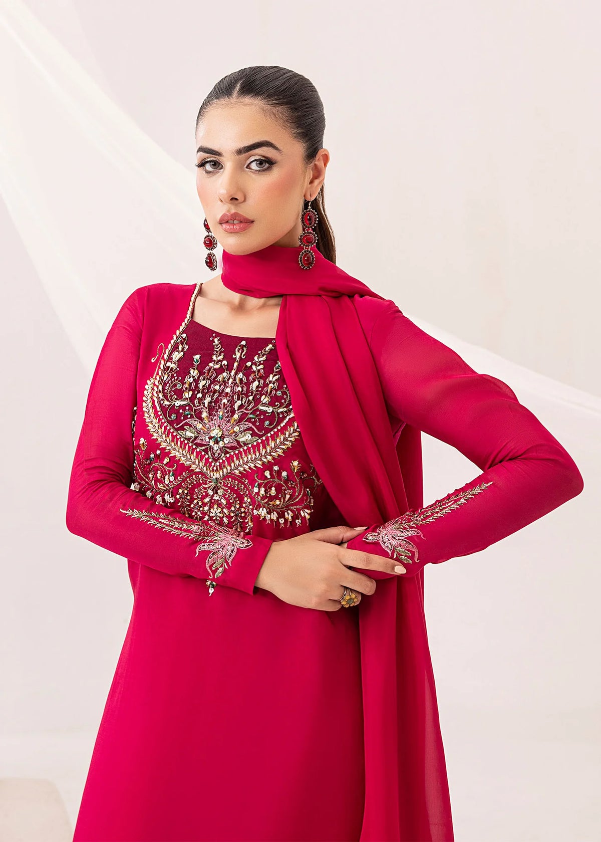 Model showcasing a red Jamnii silk 3 piece suit at Buraq Store