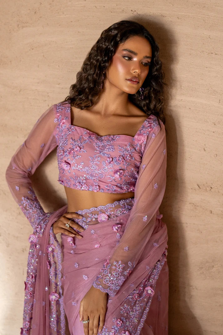 Women wearing rose pink pakistani designer saree with matching net blouse, side view of the 2PC set at Buraqstore