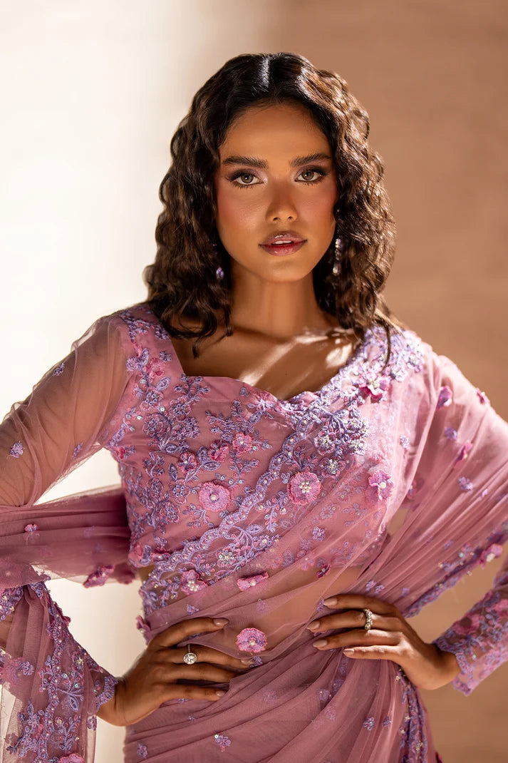 Women wearing rose pink pakistani designer saree as a party look, shop net saree online at Buraqstore