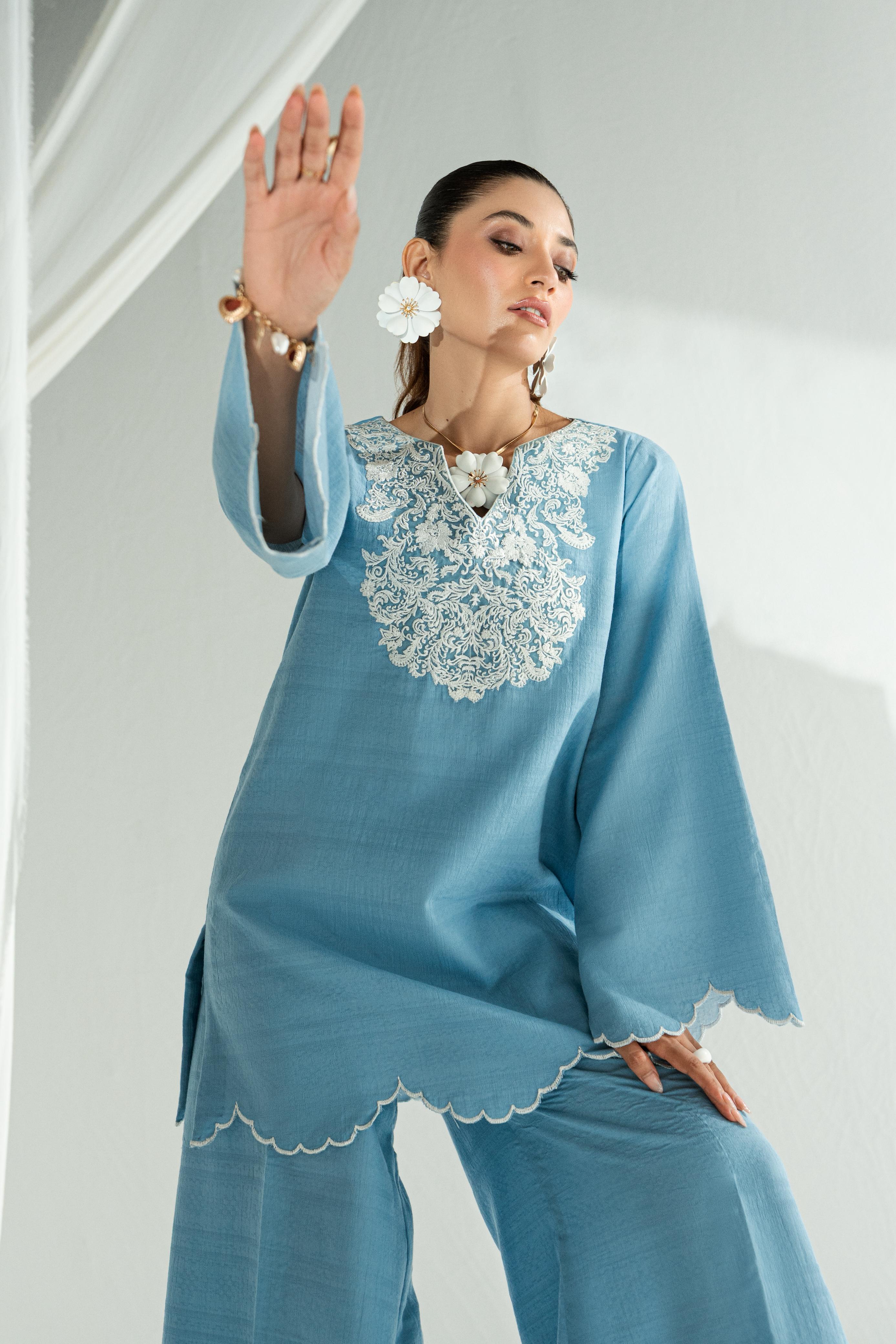 woman posing in sapphire blue dress by Buraqstore elegant pret wear