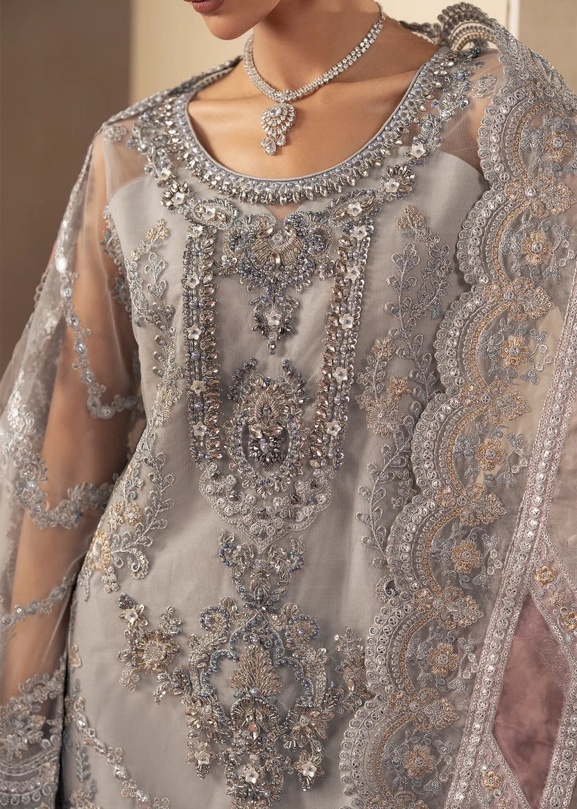 Model wearing silver colour dress, side view showing the flare of the gharara, Buraqstore