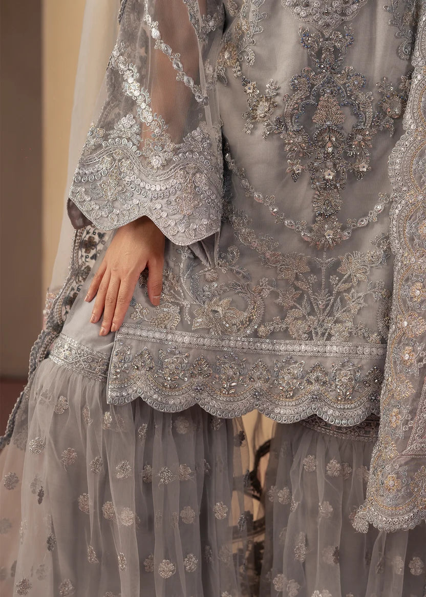 Women wearing silver colour dress, net dupatta draped over the shoulder, Buraqstore