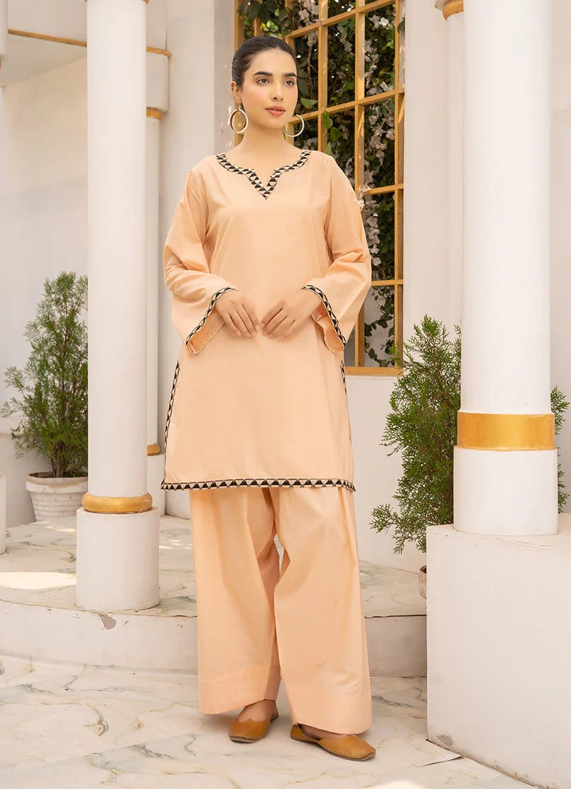 Model wearing co ord set design in soft peach, a cotton top and bottom with dori and lace detailing, front view from Buraqstore