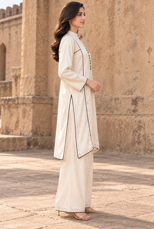 A girl dressed in linen shirt design for girl 2PC, back view of the stitched dyed linen shirt, available at Buraqstore