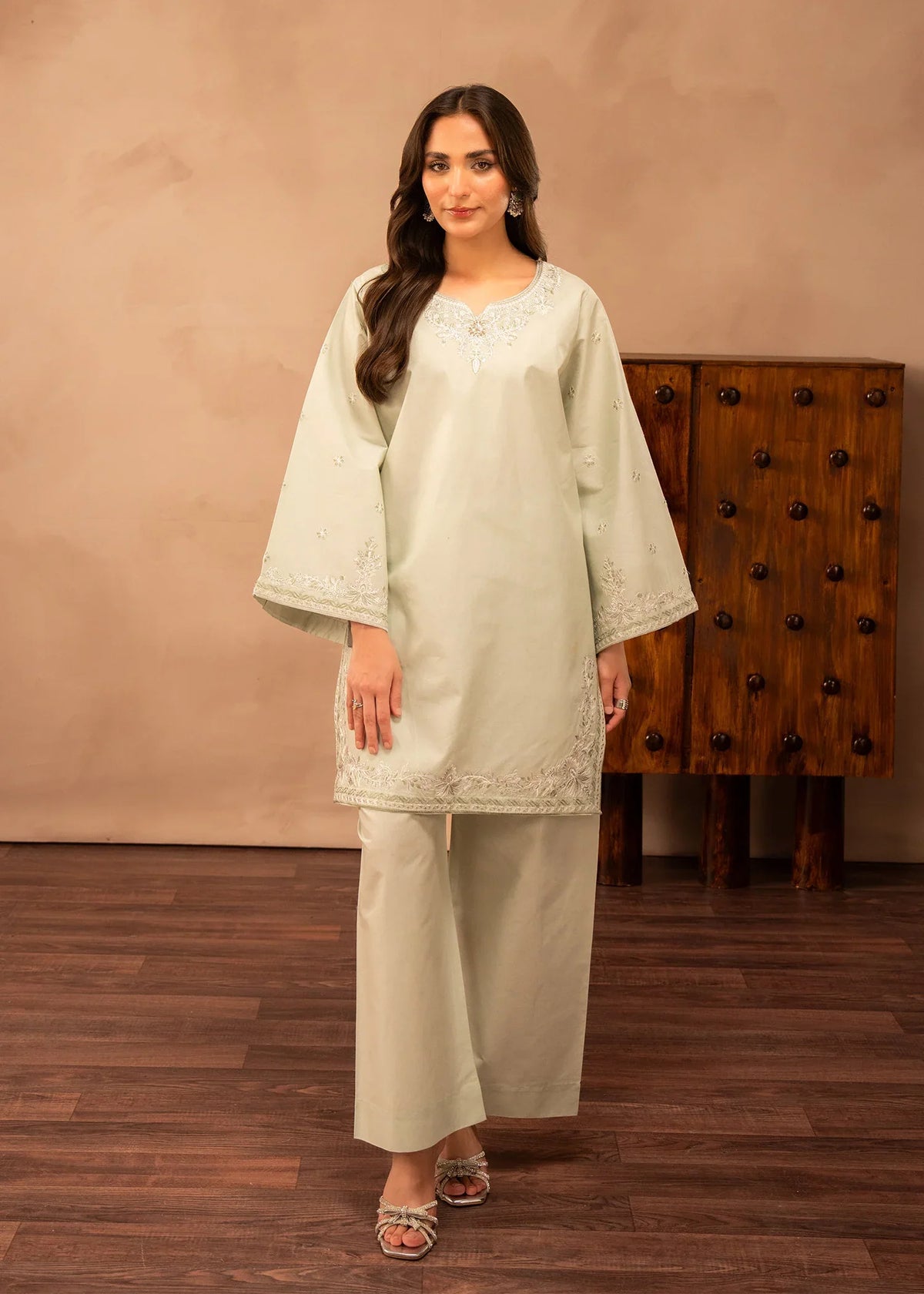 Model wearing green dress design in a soft tea shade, embroidered lawn 2PC set, front view from Buraqstore
