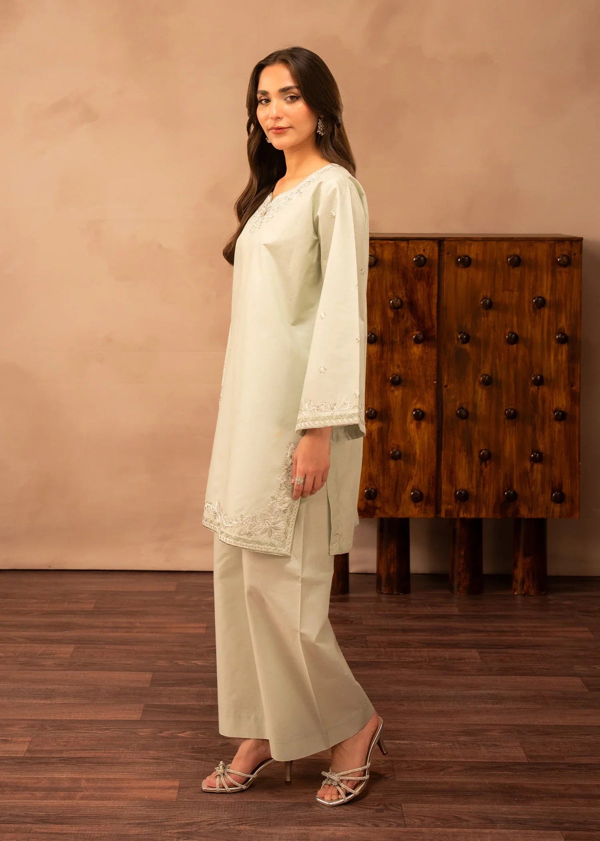 Model wearing green dress design, side view showing the fit of the embroidered lawn 2PC, Buraqstore