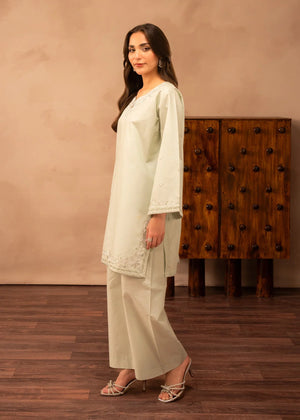 Model wearing green dress design, side view showing the fit of the embroidered lawn 2PC, Buraqstore