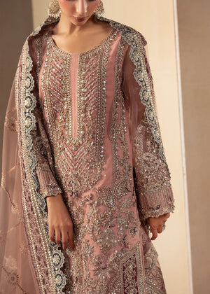 Model wearing tea pink color dress, side view showing the flare of the gharara, Buraqstore