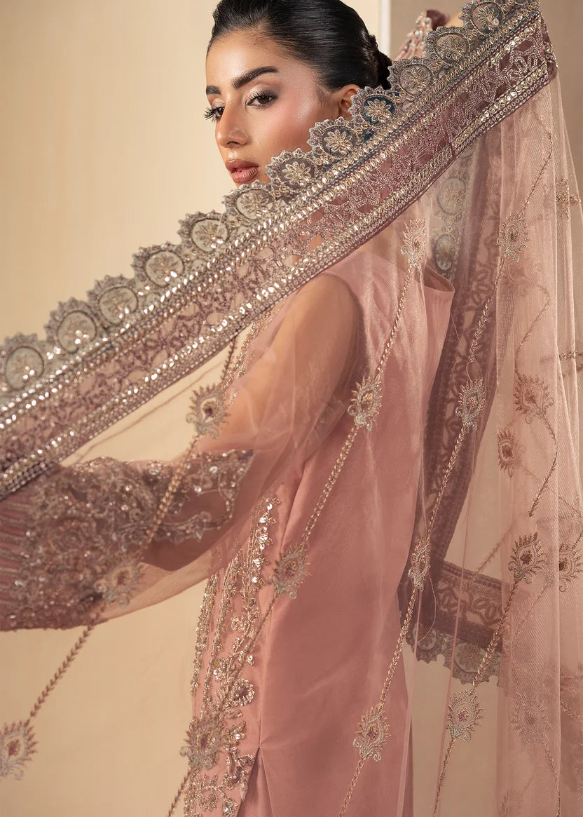 Model wearing tea pink color dress as a festive outfit, shop the embroidered gharara 3-piece set at Buraqstore