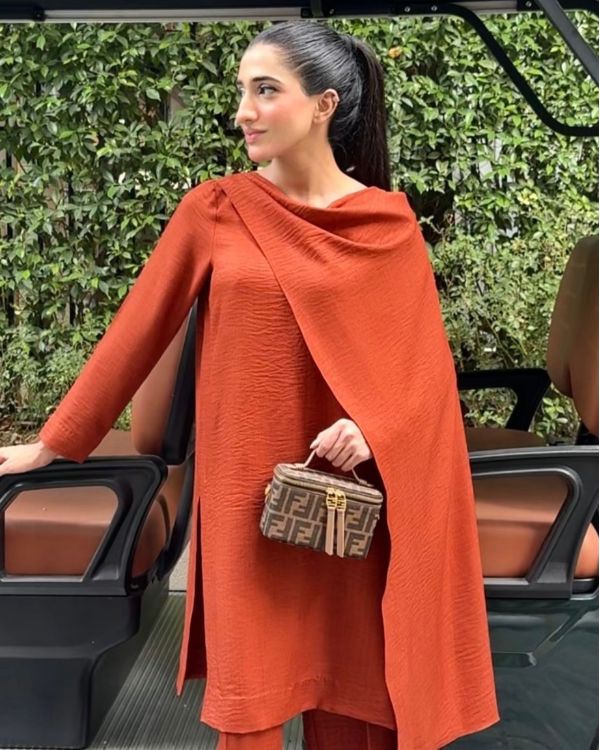 Model wearing terracotta rust dress, side view showing the fit of the pashmina 3-piece set, Buraqstore