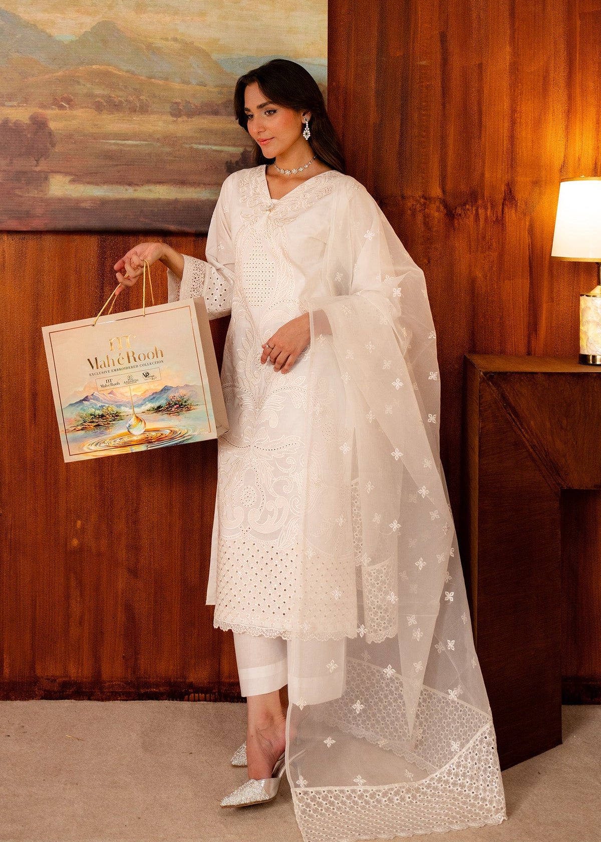 Women wearing white dress design, net dupatta draped over the shoulder, Buraqstore