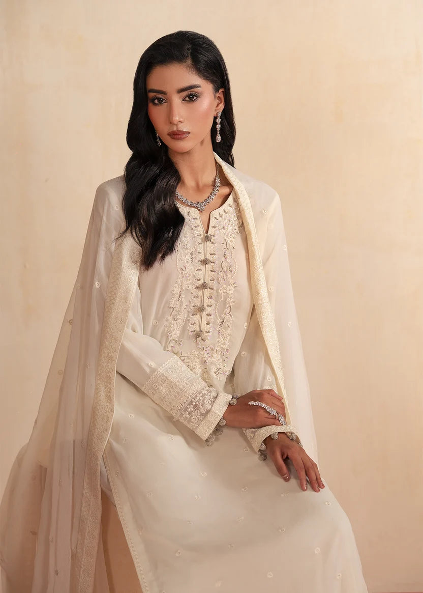 Woman wearing white dress design, close-up of the embroidery and embellishment on the chiffon shirt, Buraqstore
