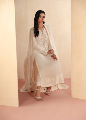 Model wearing white dress design as a festive outfit, shop the embroidered chiffon 3-piece set at Buraqstore
