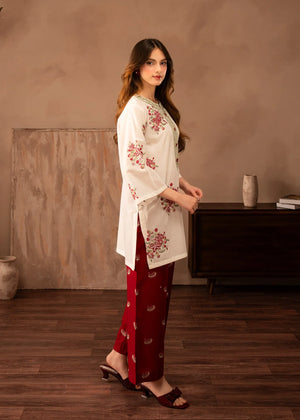 Model wearing red dress design, side view showing the fit of the embroidered lawn 2PC, Buraqstore