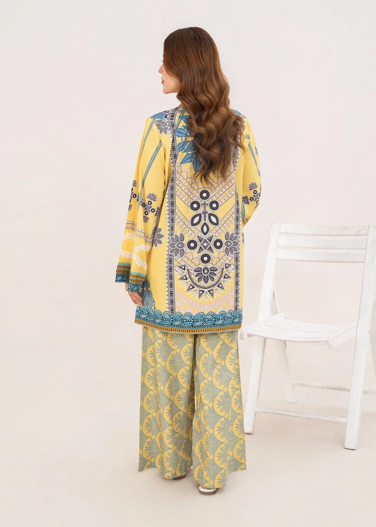 Model wearing yellow 2 piece co ord set Pakistan in a relaxed standing pose, printed grip set at Buraqstore