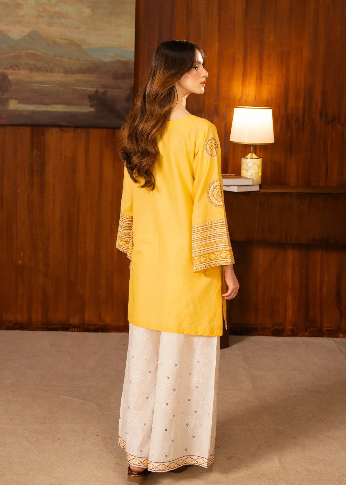 Women wearing yellow dress design, close-up of the embroidery on the white lawn shirt, Buraqstore