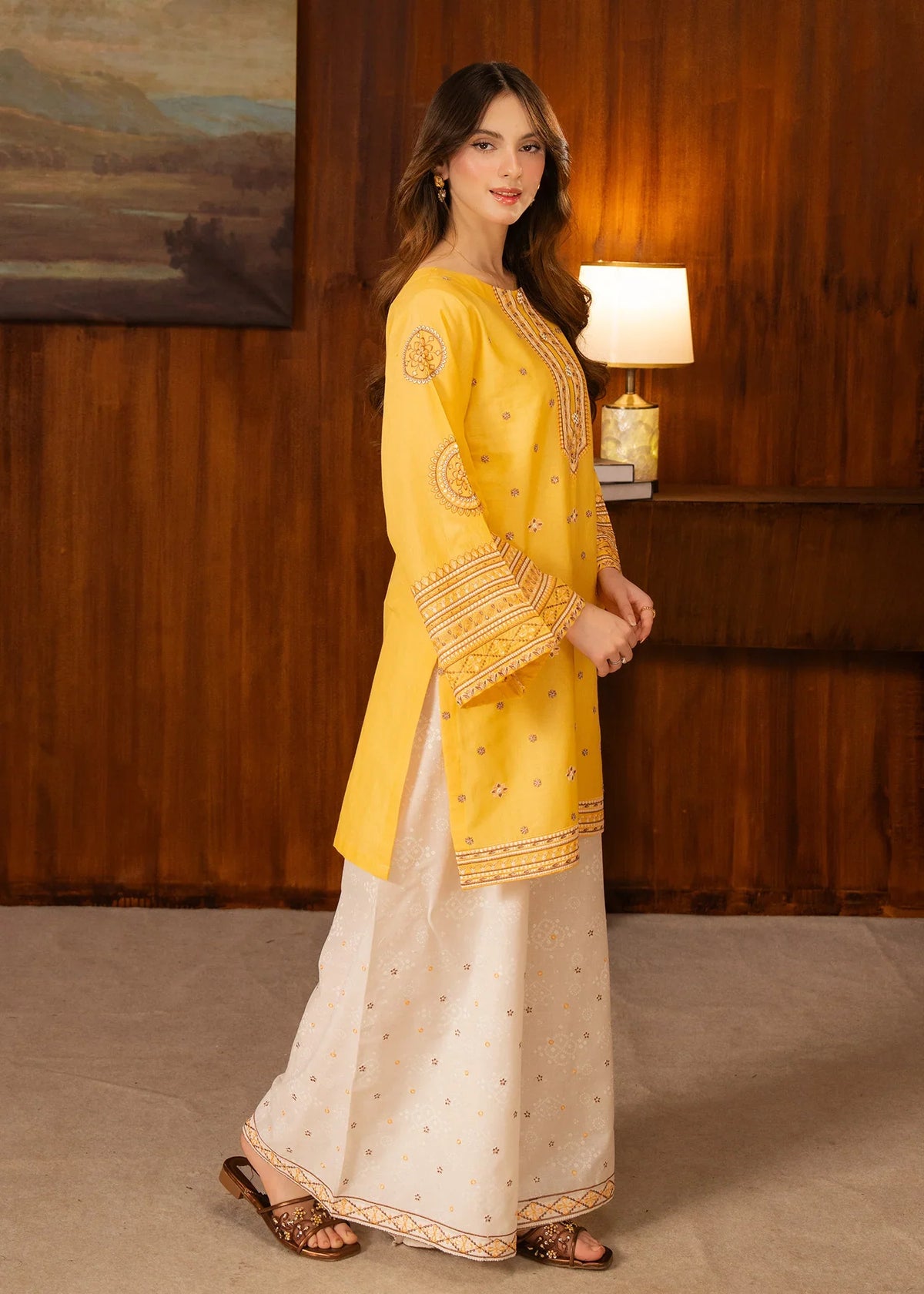 Model wearing yellow dress design, side view showing the fit of the embroidered lawn 2PC, Buraqstore