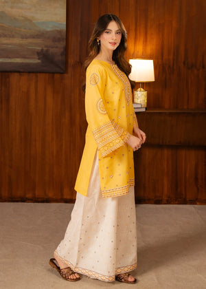 Model wearing yellow dress design, side view showing the fit of the embroidered lawn 2PC, Buraqstore