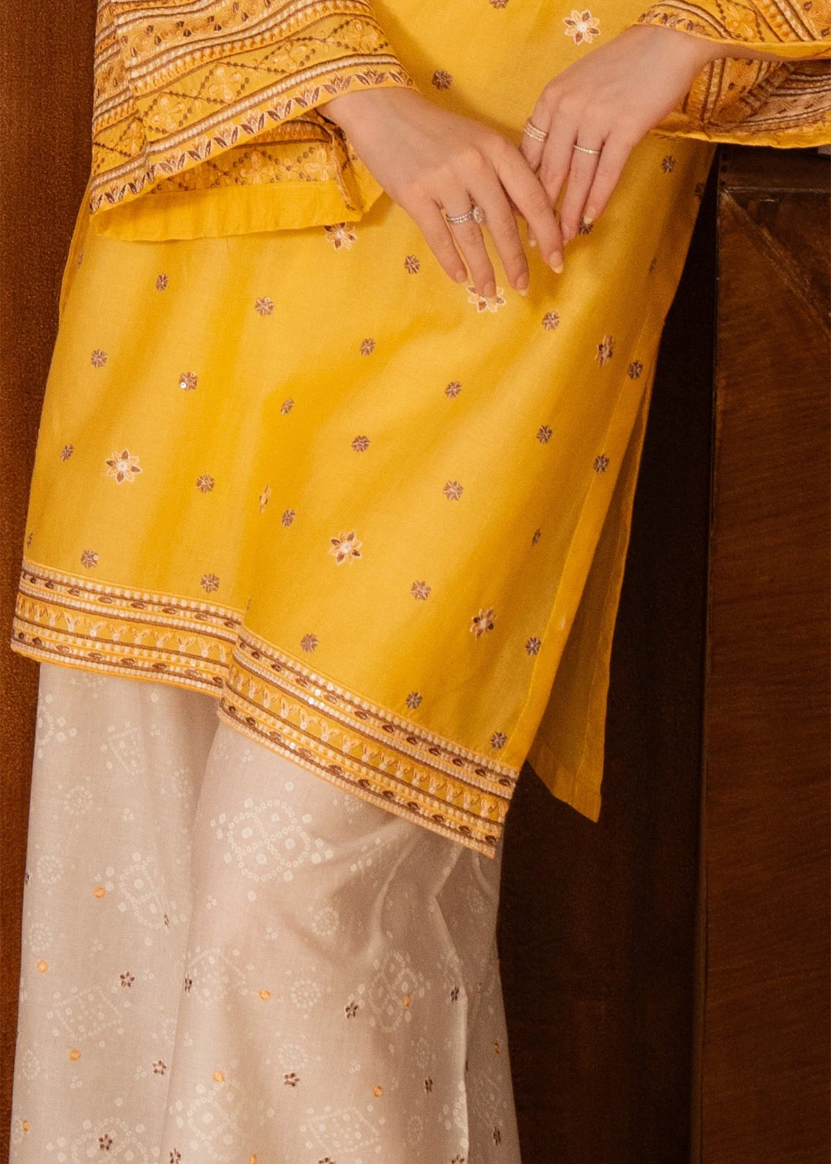 Model wearing yellow dress design as a casual outfit, shop embroidered lawn 2PC at Buraqstore