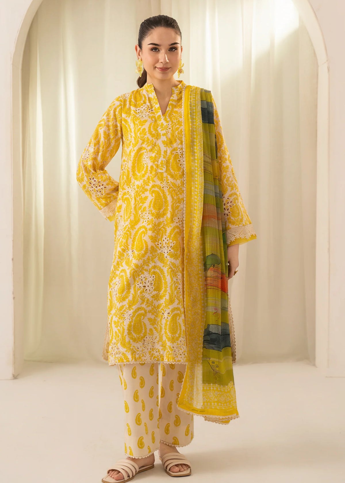 Woman wearing a yellow Meerak Chikankari lawn suit from Buraq Store